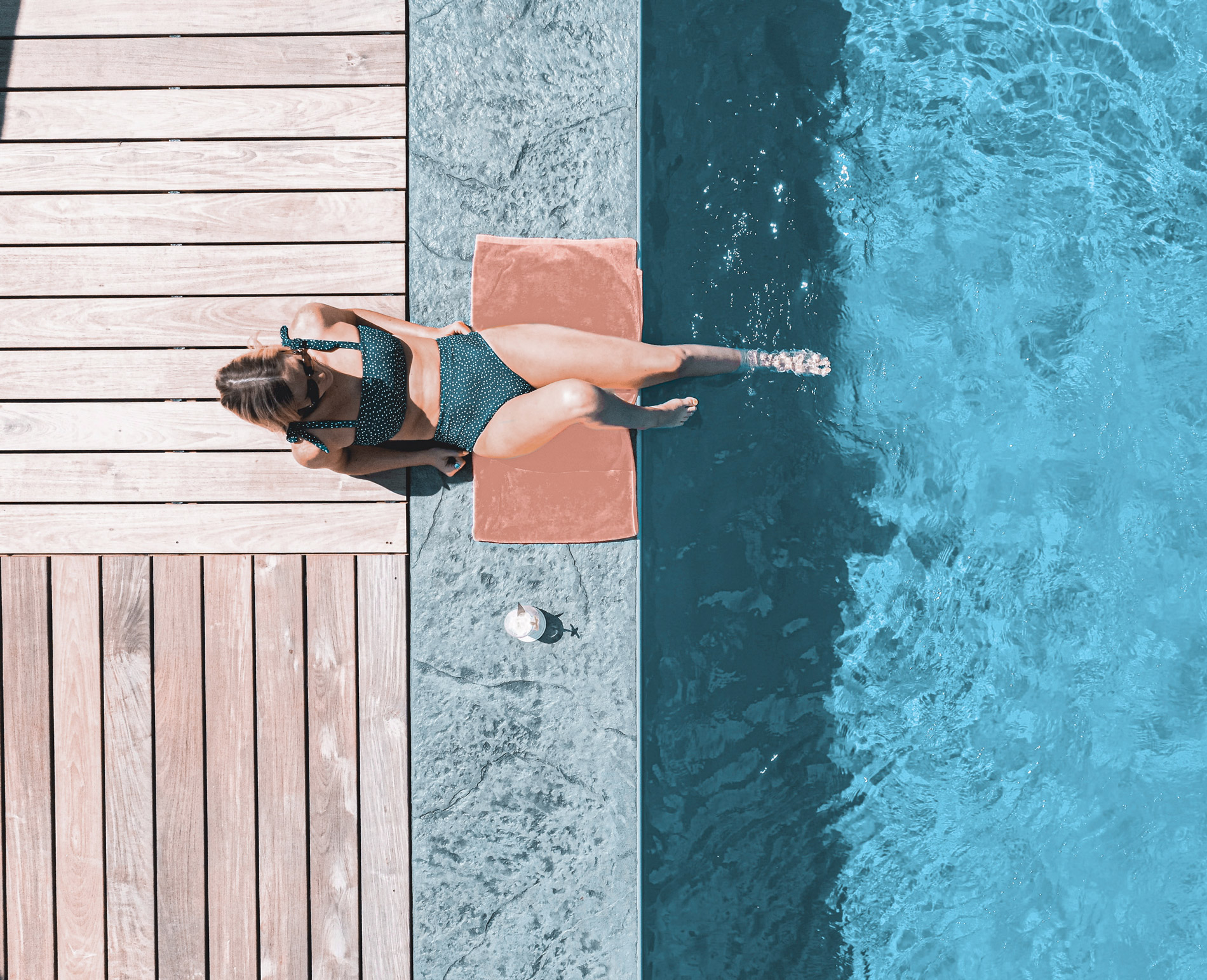 young woman resting next to a bespoke Bluefino pool